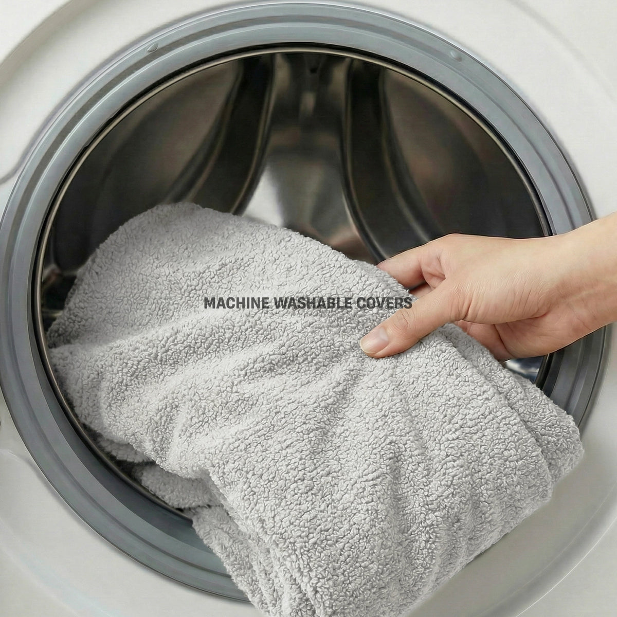 Grey Bouclé dog bed cover being removed for machine washing.